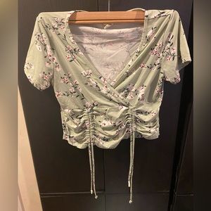 Woman’s green crop top with flowered pattern